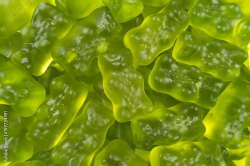 Green jelly babies / gummy bear candy sweets. Potential use as a background.
