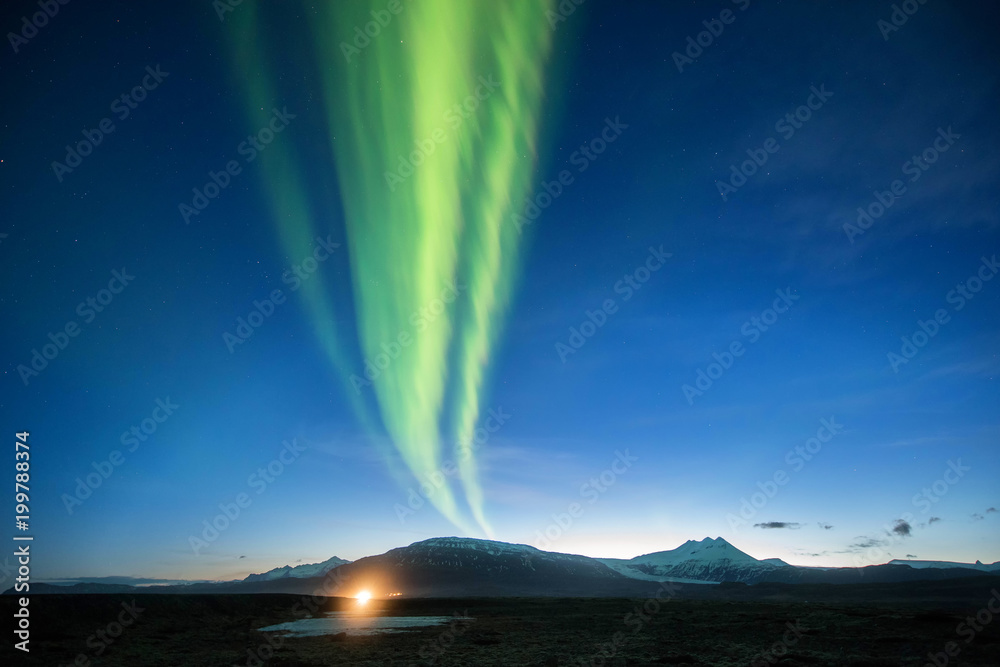 A wonderful night with Kp 5 . Northern lights mountain in Iceland.