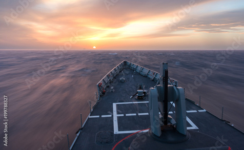 Canvas Print A background of a war ship in the naval base during sunset