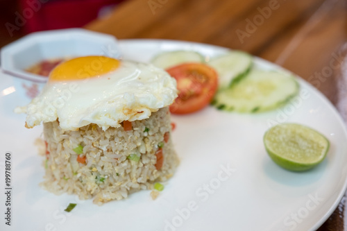 Fried rice with fried egg served on plate