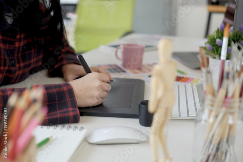 Young graphic designer working in studio.