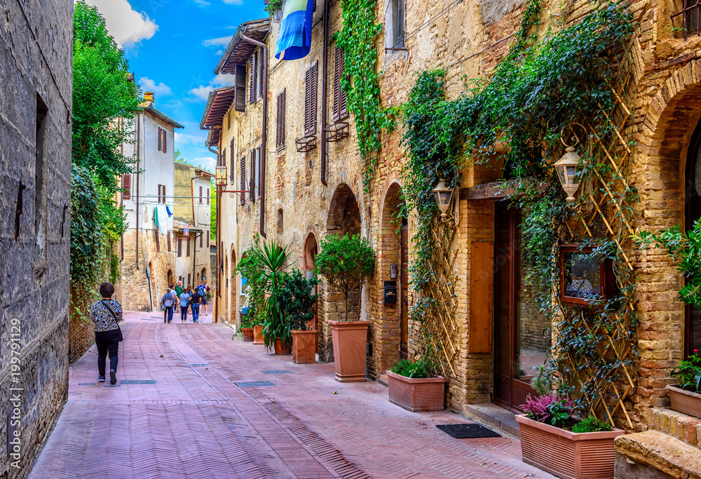 Old street in San Gimignano, Tuscany, Italy. San Gimignano is typical ...