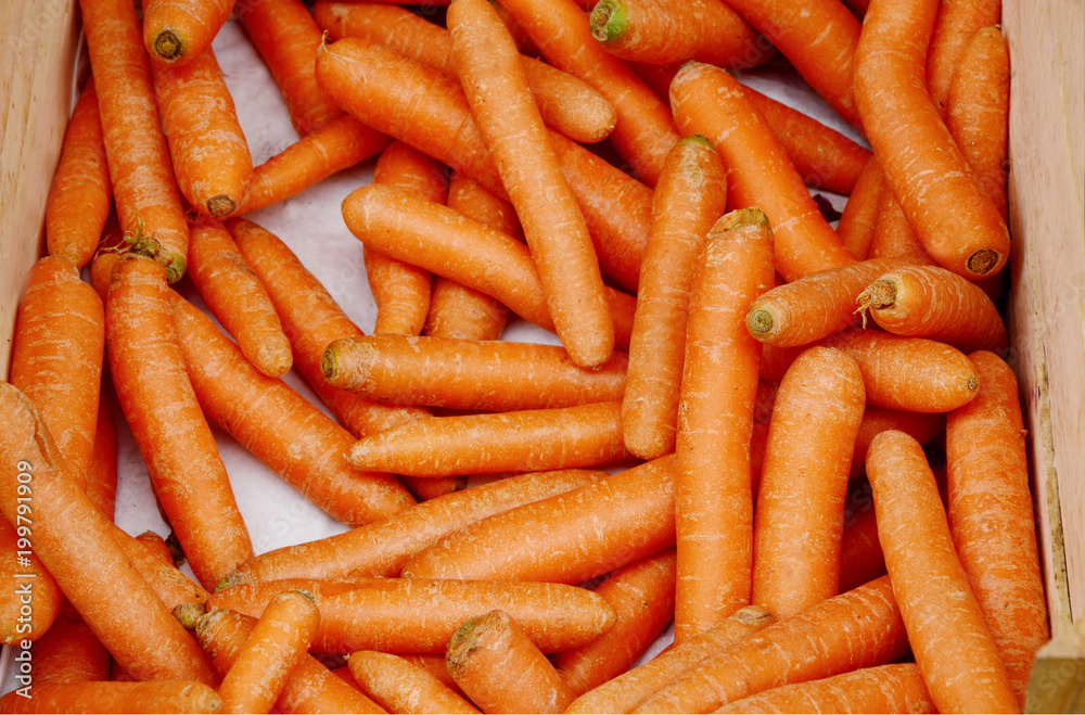 a lot of Bio carrot with wooden box in the morning market a lot of Bio carrot with wooden box in the morning market