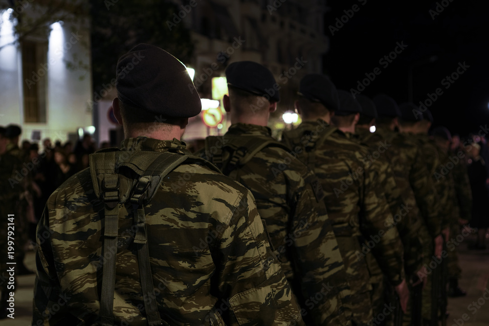 Greek Army soldiers with black berets in combat uniforms. Selective focus silhouette of Hellenic Armed forces males wearing Combat Uniforms in a Camouflage Pattern.