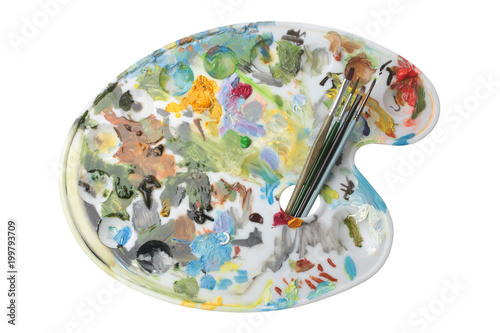 Palette with oil paint and paintbrushes