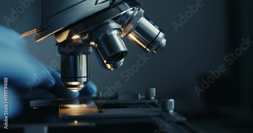 Scientist hands with microscope close-up shot in the laboratory