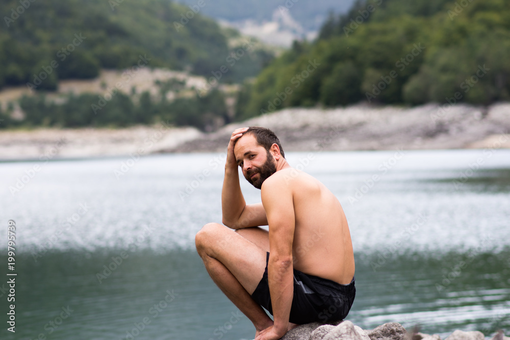 Fototapeta premium man enjoy near a mountain lake.