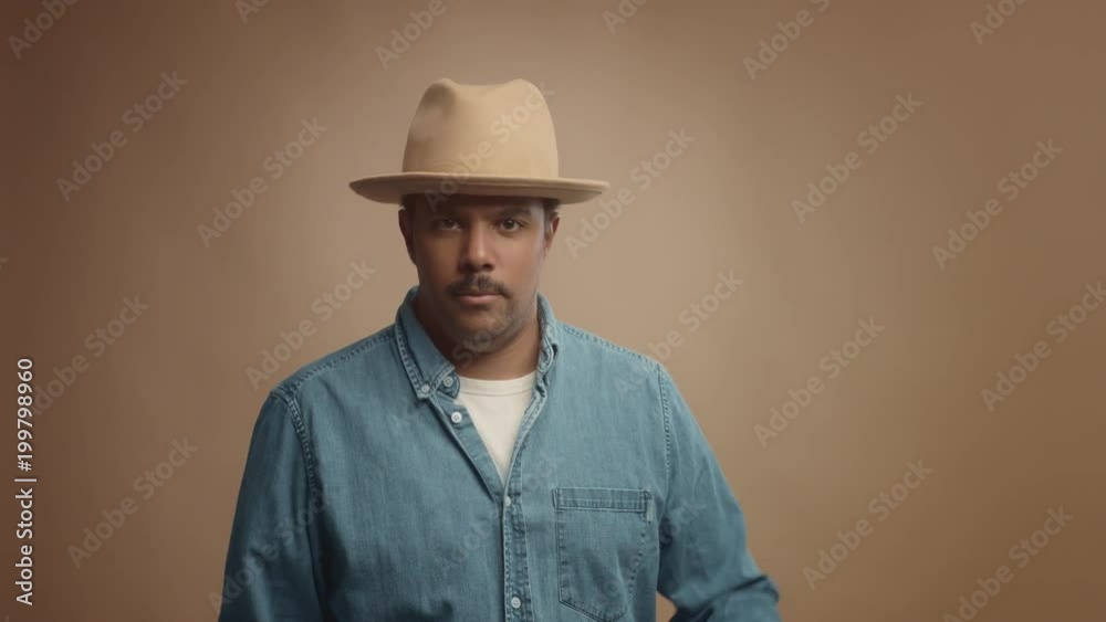 mixed race black man on beige background in studio portrait Colorfull clothes lineal dolly zoom mixed race black man on beige background in studio portrait Colorfull clothes lineal dolly zoom