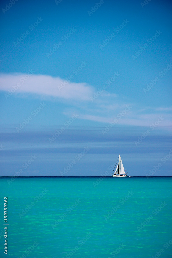 White sailboat against blue sky and sea, Antigua, Antigua and Baruda.