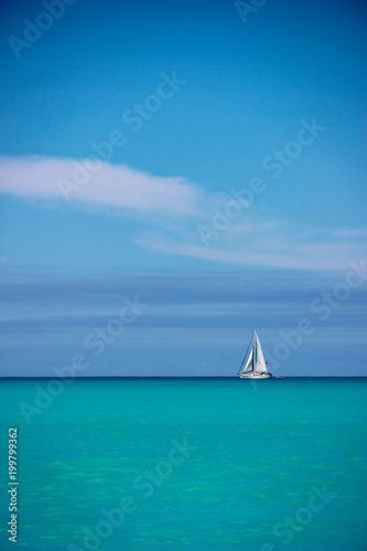 White sailboat against blue sky and sea, Antigua, Antigua and Baruda.