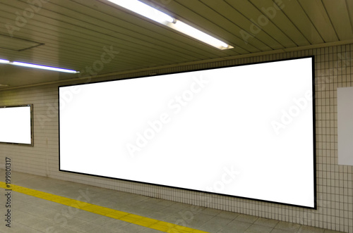 big blank advertising billboard on wall with copy space for your text message or media and content in subway train station or airport, information board, banner, marketing and advertising concept