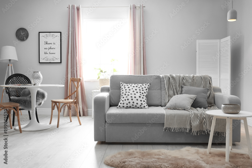 Obraz premium Stylish living room interior with comfortable couch