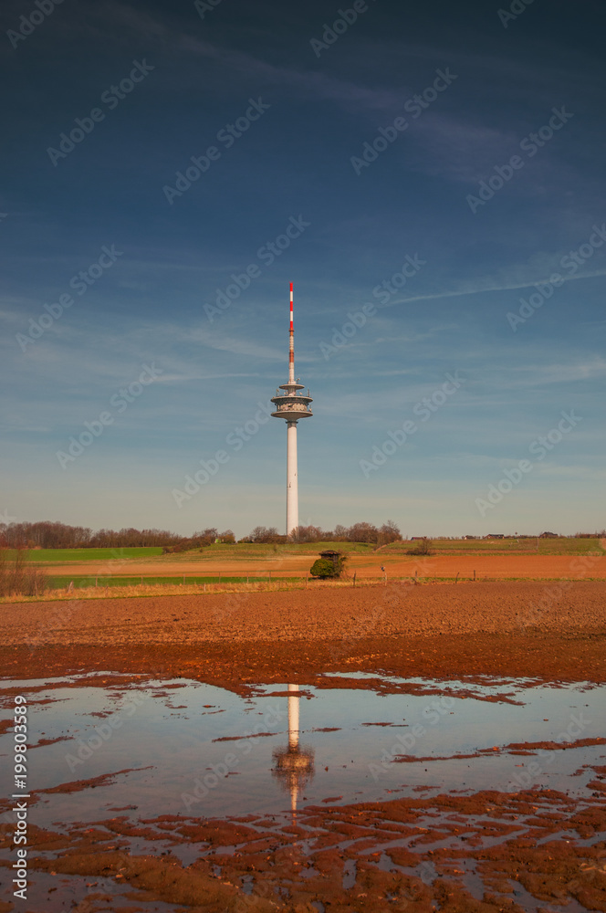 Obraz premium View of a Radio mast and tower with landscape field view. Fernmeldeturm Broitzem in Braunschweig, Germany