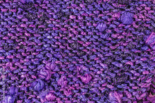 knitted fabric background in shades of pink and purple with knobs © seramoje