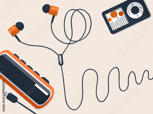 Headphones, music player and mini speaker on the table with place for your text.