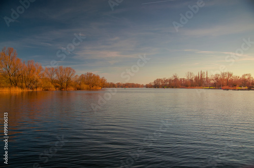 Panorama view of a lake with blue sky and golden sunset light. Südsee in Braunschweig, Germany © Ricardo