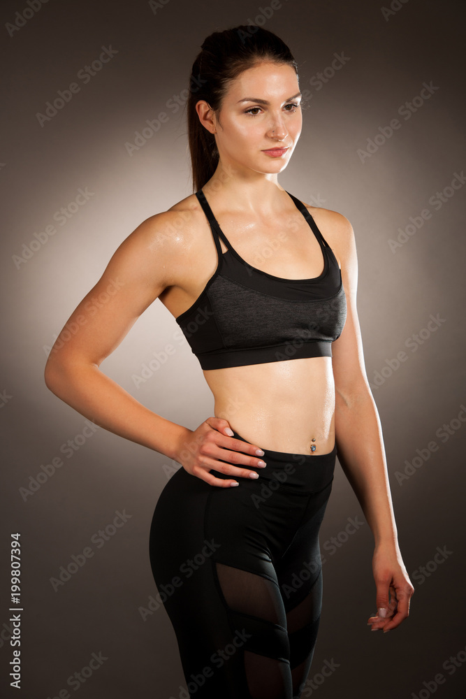 Active young fit woman with perfect body pose