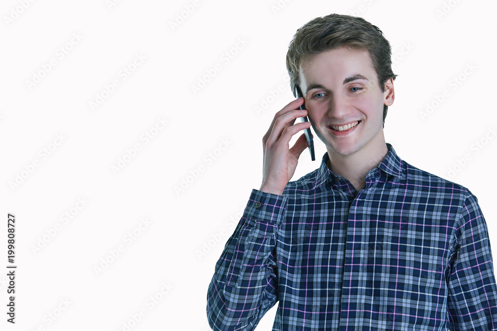 Cheerful young man speaking on the phone on white background. Cheerful young man speaking on the phone on white background.