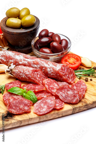 Dried organic salami sausage or chorizo on wooden cutting board