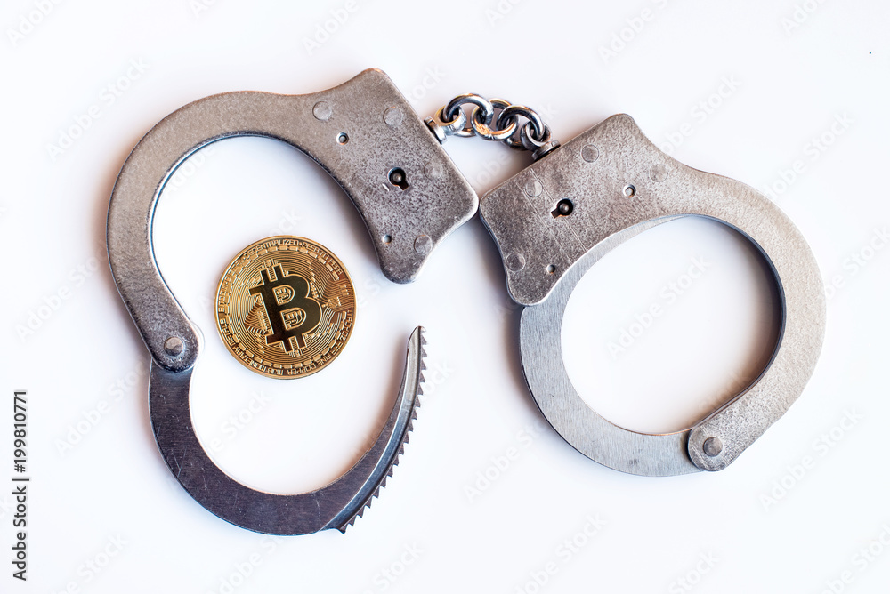 Bitcoins and handcuffs as an abstract symbol of crime that can hide a crypto currency Bitcoins and handcuffs as an abstract symbol of crime that can hide a crypto currency