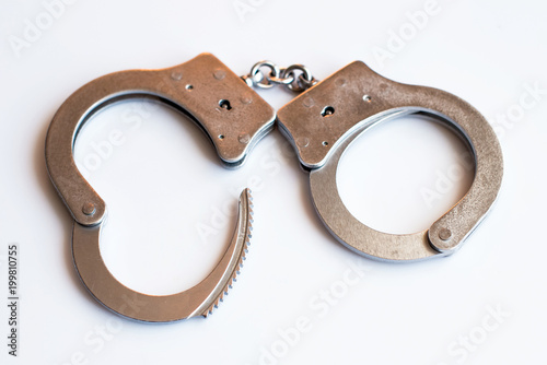 Obraz na płótnie Open cufflinks close-up as a symbol of release from the responsibility of criminals and the avoidance of punishment for the committed crimes w salonie