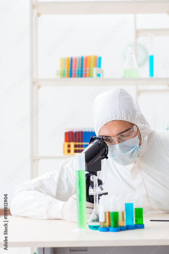Young chemist student working in lab on chemicals Young chemist student working in lab on chemicals