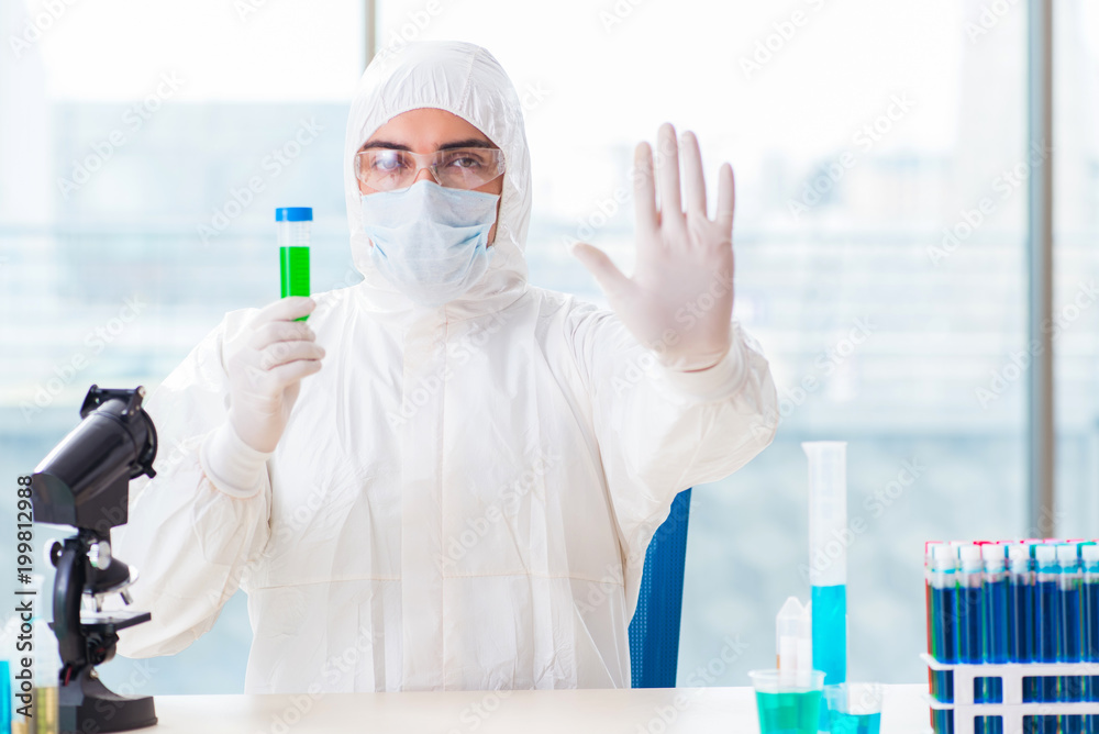 Young chemist student working in lab on chemicals Young chemist student working in lab on chemicals