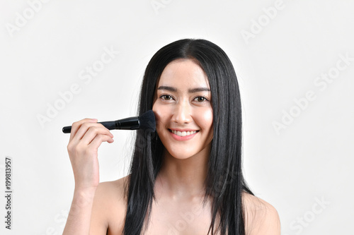 The concept of healthy beautiful woman. Beautiful girl Make up with cosmetics. Beautiful women use cosmetics suitable for the face. Beautiful woman makeup on isolated background