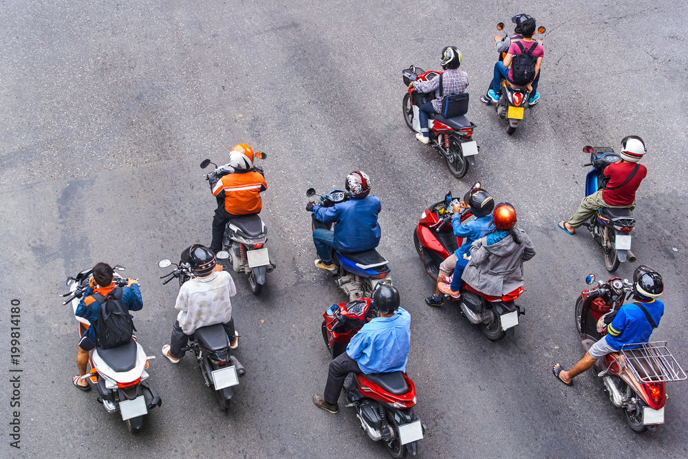 Naklejka premium People are on motorbikes in huge Asian city