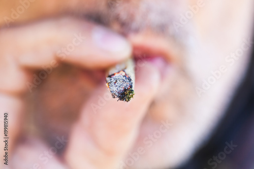 man smokes cannabis