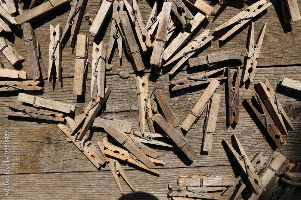 wooden clothes pegs on the brown table wooden clothes pegs on the brown table