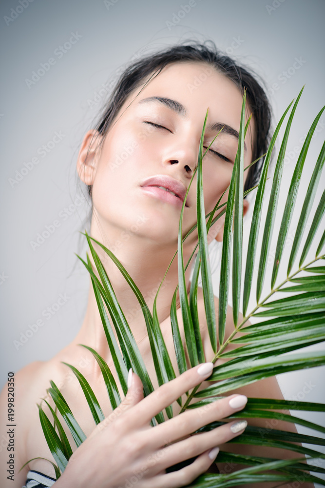 Fototapeta premium woman with tropical leaf