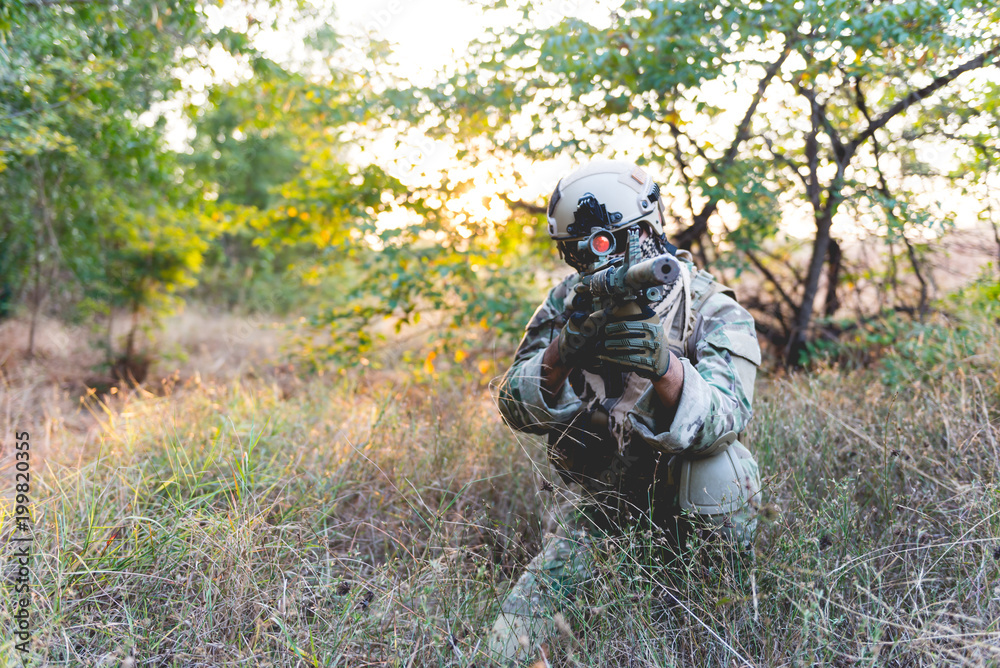 Soldiers are preparing to hit the enemy in the forest on sunset,military in war concept Soldiers are preparing to hit the enemy in the forest on sunset,military in war concept