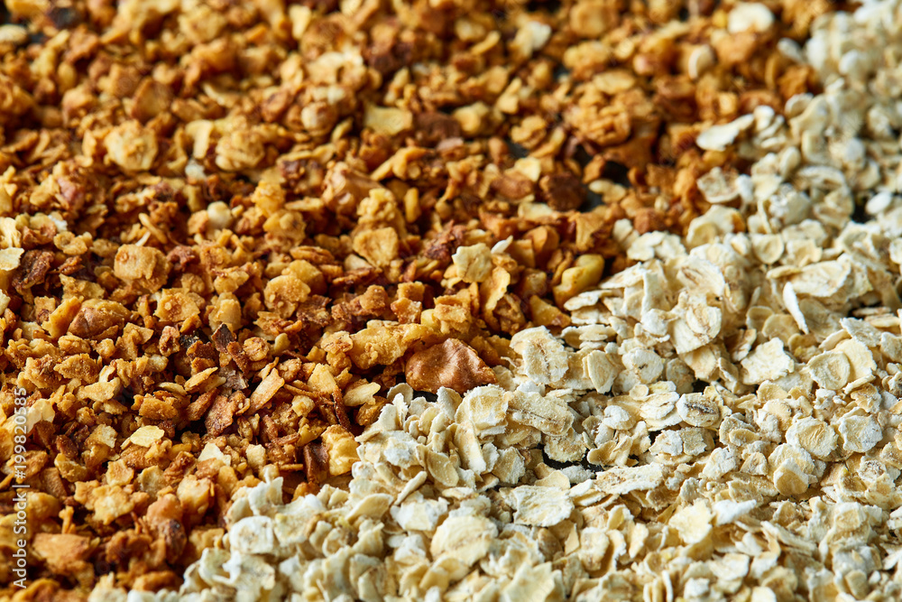 Healthy mix of granola and oatmeal on dark background, top view, close-up, selective focus Healthy mix of granola and oatmeal on dark background, top view, close-up, selective focus