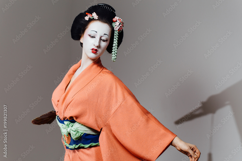 Woman in geisha makeup and a traditional Japanese kimono. Studio, Indoor.  Stock Photo | Adobe Stock