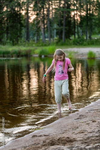 Young girl in the evening on the lake