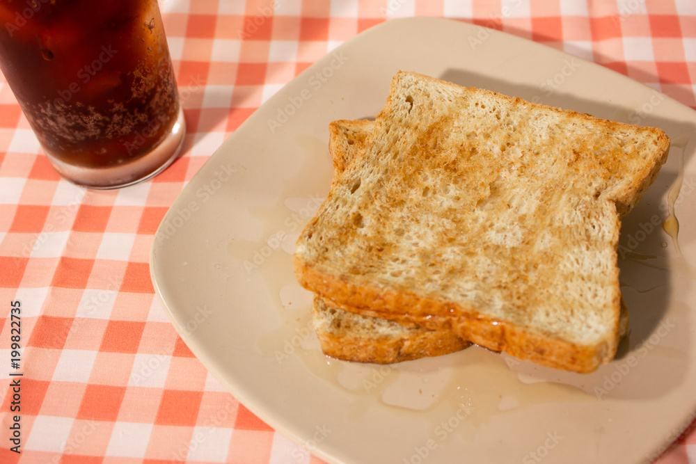Honey bread with cola on tablecloth background. Closeup. Honey bread with cola on tablecloth background. Closeup.