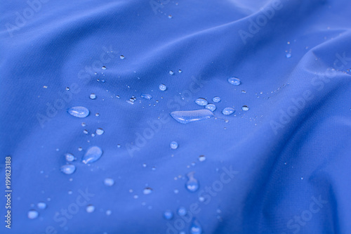Water repellent coating durable repellency fabric outdoor shell jacket with water drops. Waterproof membrane with droplets. photo