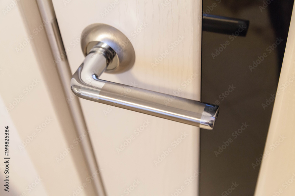 Beige door with chrome door handle, selective focus Beige door with chrome door handle, selective focus