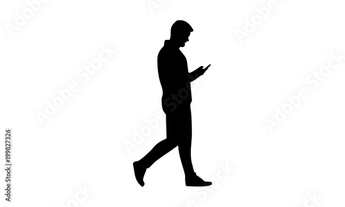 silhouette man walking while holding the phone