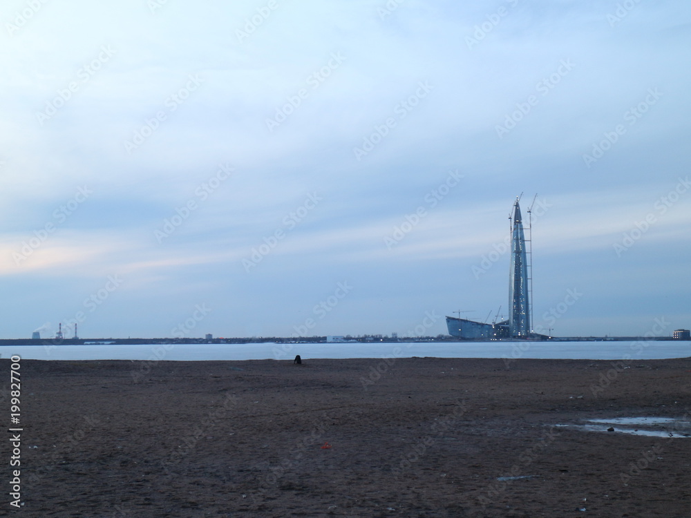 skyscraper standing on the shore of a frozen bay