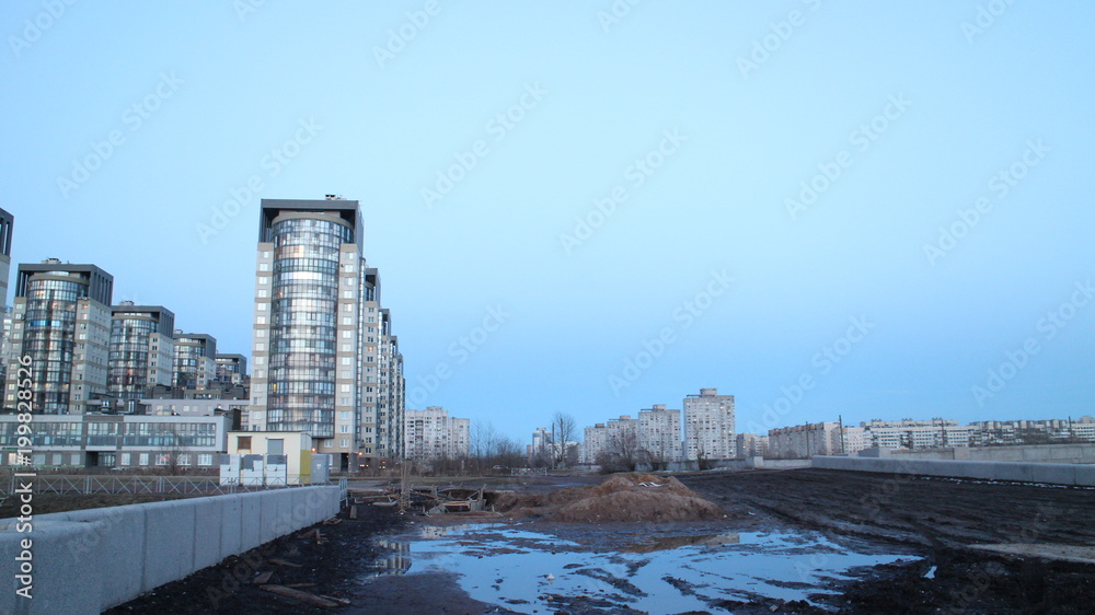 Naklejka premium Evening city quarter on the river bank