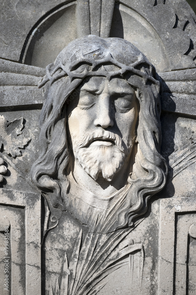 Figure of Jesus Christ on tombstone in little graveyard on island Brac in Croatia