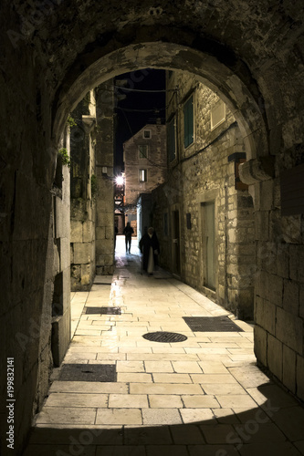 Night view of narrow mediterranean street with vaulted passage in Diocletian palace, town Split in Croatia
