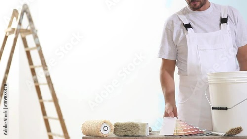 painter man at work choice color with swatches samples, wall painting concept, white copy space background