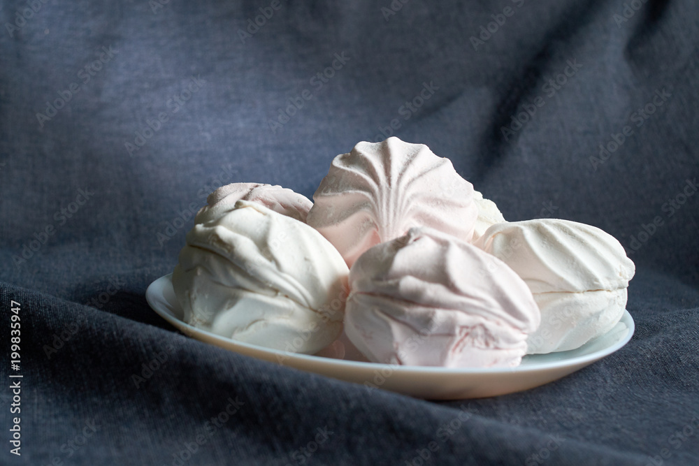 White zephyr marshmallow on porcelain plate White zephyr marshmallow on porcelain plate