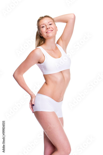 Young beautiful blonde woman in white fitness clothing