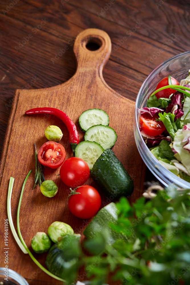 fresh vegetables on the cutting board over wooden background, selective focus, shallow depth of field fresh vegetables on the cutting board over wooden background, selective focus, shallow depth of field