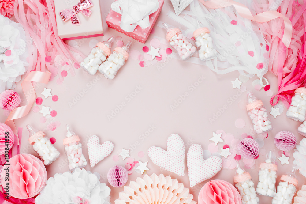 Frame made of Pink and white Paper Decorations for Baby shower party. It's a Girl. Flat lay, top view Frame made of Pink and white Paper Decorations for Baby shower party. It's a Girl. Flat lay, top view