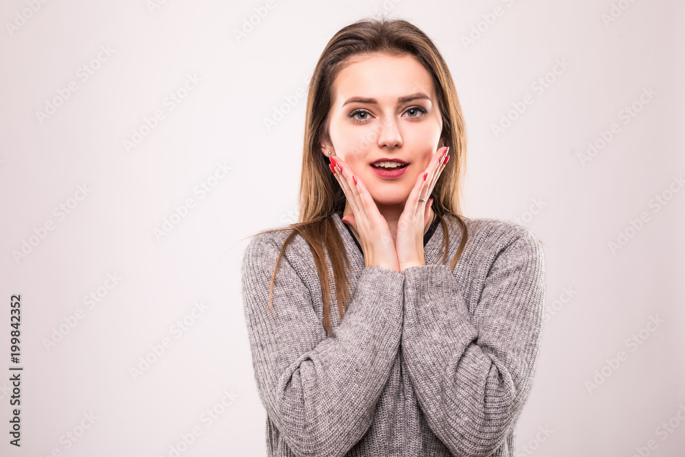 Portrait of shocked woman with mouth open looking away isolated on a gray Portrait of shocked woman with mouth open looking away isolated on a gray